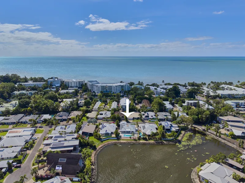Aerial view of the Blue Lagoon Estate at Trinity Beach showing the lagoon waterways and the Coral Sea beyond