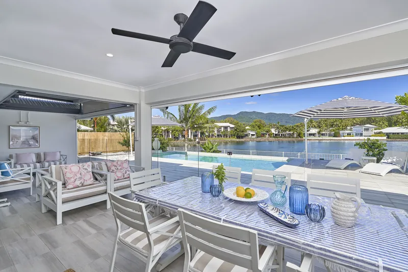 Open-plan living area at Villa Aura opening directly onto the pool deck and lagoon view