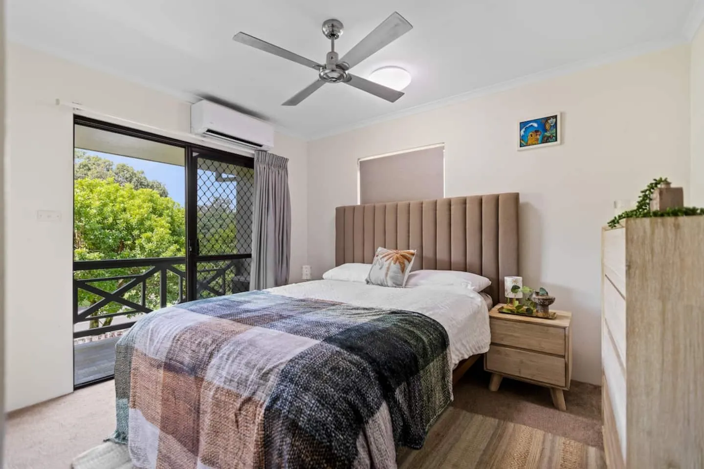 Queen bedroom with ceiling fan and air-conditioning