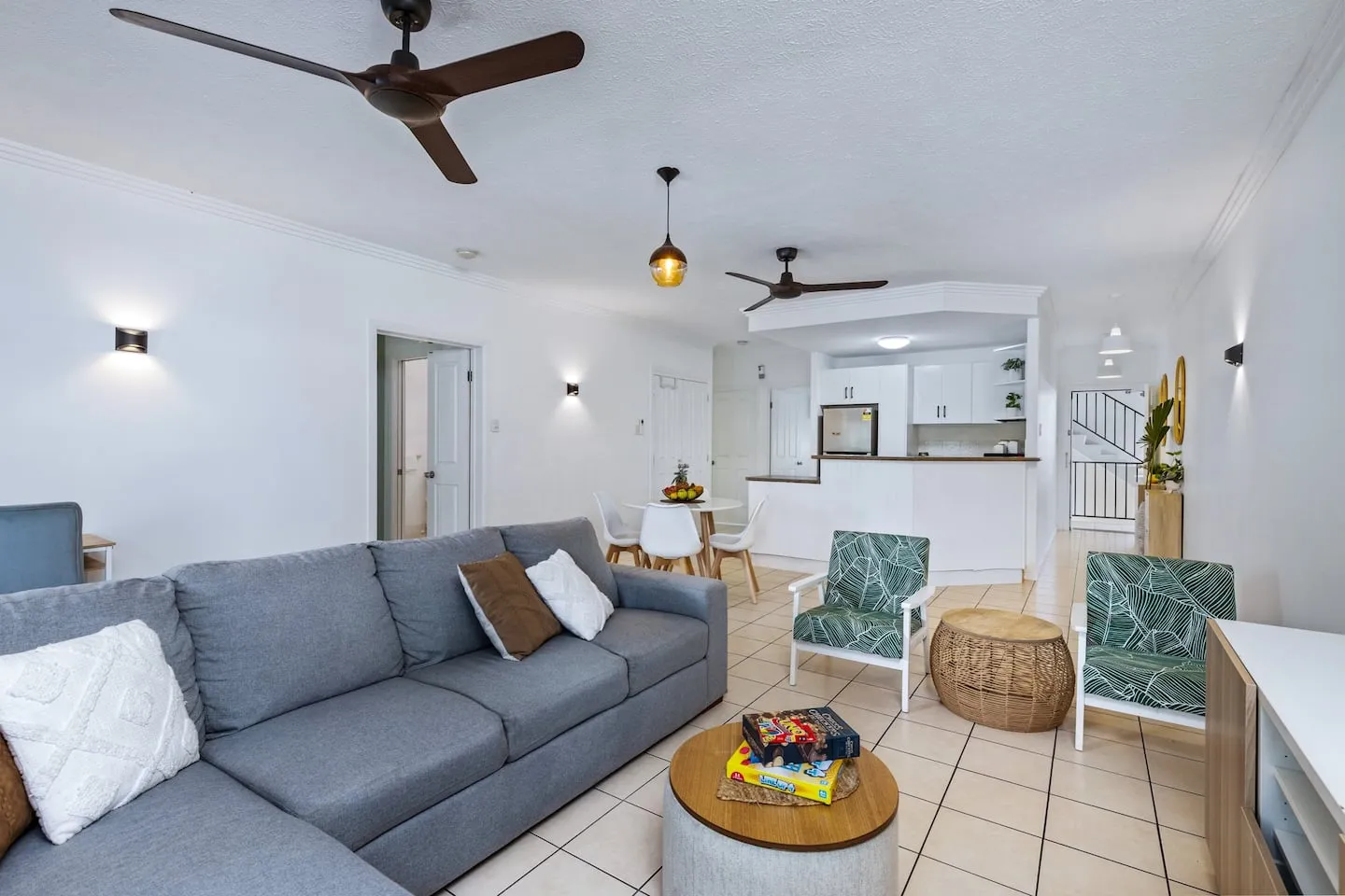 Living room with sofa, TV and open-plan kitchen