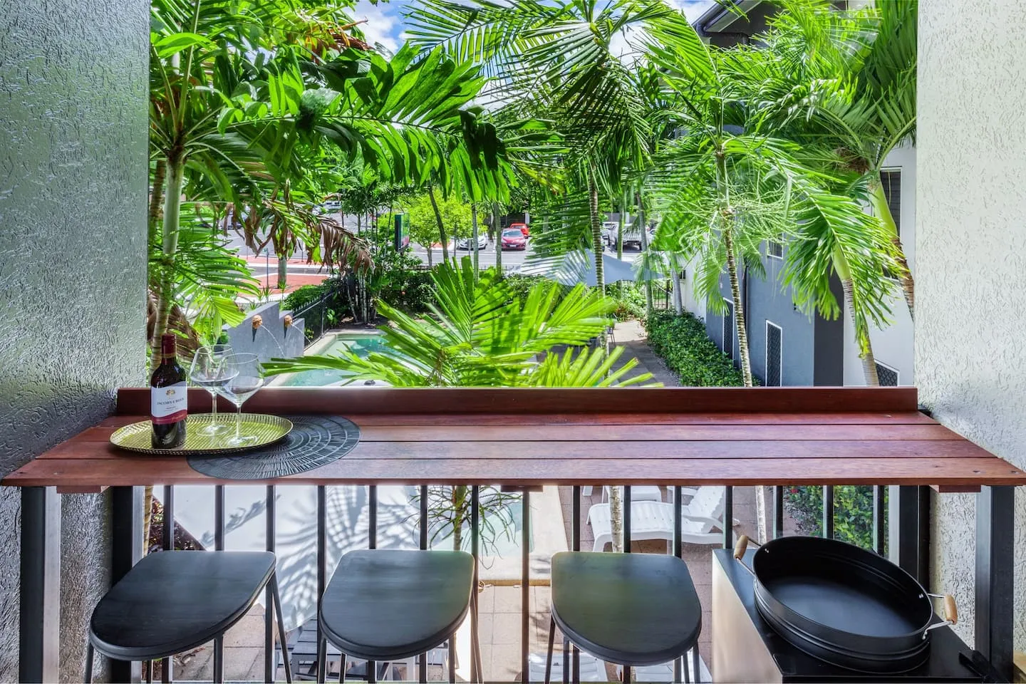 Balcony bar overlooking the pool and palms